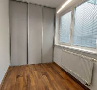 Children's room with wood-patterned flooring in a 2-room apartment.