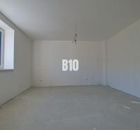 An empty room with a large window in a family house.
