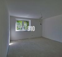Empty room in a family house with a concrete floor and a large window.
