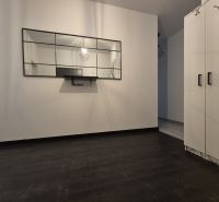 Mirror in a 3-room apartment, floor with wood decor, white cabinets.
