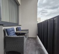 Balcony with seating and tiles, 3-room apartment, privacy for relaxation.