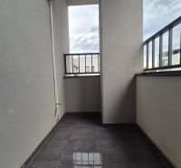 A balcony with ceramic tiles and a railing in a 3-room apartment.