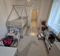 A children's room with a house-shaped bed, toys, and a kitchenette in a 3-room apartment.