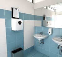 Bathroom in offices with white and blue tiles, sinks, and a mirror.