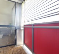 Balcony with external blinds and entrance to the living room, floor with wooden decor.