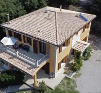 A villa on G. Puccini Street in Perugia with a terrace, surrounded by greenery and a garden.