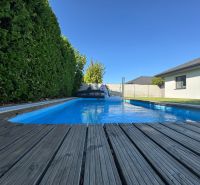 A swimming pool at a family house on Slnečnicová Street in Miloslavov, surrounded by greenery.