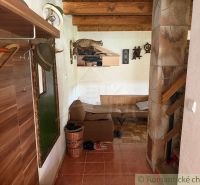 A cottage with a wooden floor decor, rustic furniture, and decorations.