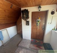 Entrance hall in a cabin with wooden paneling and imaginative wall decoration.