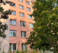 Apartment building on Žilinská Street in Trenčín, hidden behind greenery and trees.