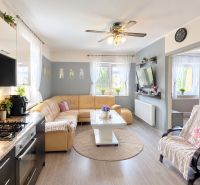 Living room in a family house with a leather sofa and a floor with a wooden decor.