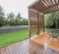 Wooden terrace with seating, lawn, hedge, 4-room apartment on Frankovská Street in Bratislava.