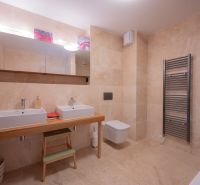 A bathroom with a double sink, mirror, and large-format tiles in a 4-room apartment.