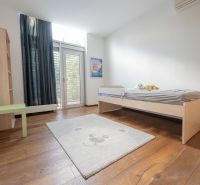 A children's room with a light bed and a wooden decor floor in a 4-room apartment.