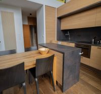 A kitchen in a 4-room apartment with wood-patterned floors and modern furniture.