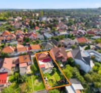 A view of a family house in Komárno with an enclosed garden and a roof.