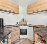 A kitchen with a stove and a dishwasher in a family house.