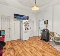 A room in a family house with a wooden decor floor and wall decorations.
