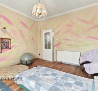 Children's room in a family house with colorful walls and a wooden decor floor.