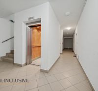 Hallway with an elevator and staircase in the building.