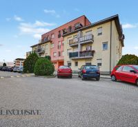 Apartment building on Platan Street in Šamorín with parking in front of the building.