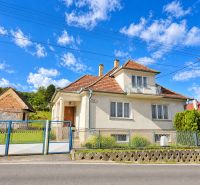 A family house on Topoľčianska Street in the town of Banka with a white facade and a garden.
