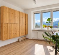 A room in a 3-room apartment with wooden furniture and a wooden decor floor.