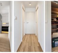A hallway in a 3-room apartment with a wooden decor floor and a spacious pantry.