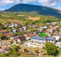 Aerial view of the village Mikušovce with beautiful nature and a view of a 3-room apartment.