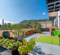 Terrace in a 3-room apartment with a view, plants, and a children's playhouse in Mikušovce.