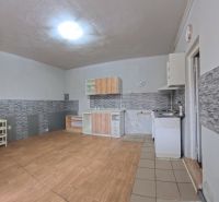 Interior of a family house with a kitchen unit and a wooden decor floor.