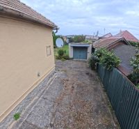 Family house on Jesenského Street in Levice, concrete area and roofs of other houses.