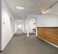 The entrance hall in offices with a wooden decor desk and lighting.