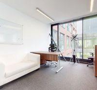 Office with a white sofa, desk, and large window.