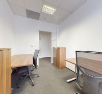 An office with wooden decor, black chairs, and white walls.