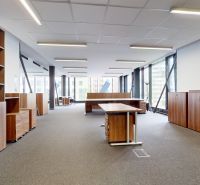 Spacious offices with wooden decor and large windows provide a pleasant working environment.