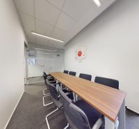 Conference room with a long table and black chairs, Offices.