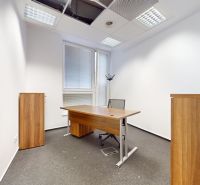 Offices with a wooden desk and an ergonomic chair, view of glass doors.