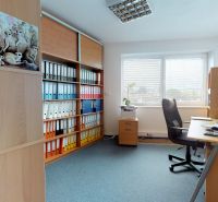 Offices with wooden decor, shelves with registries, and a view from the window.