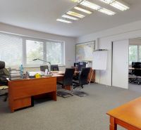 Offices with carpeted floors and wood-decor furniture, separated by sliding doors.