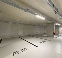 Parking spaces in indoor garages with numbering on the concrete floor.