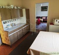 A kitchen in a family house with a classic cabinet and table, simple design.
