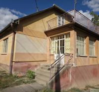 A family house in Sečianky with a glass veranda and staircase.