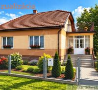 A family house in Sečianky with a garden, a balcony, and floral decorations at the entrance.