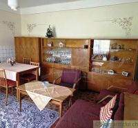 Living room in a family house with wooden furniture and decorations.