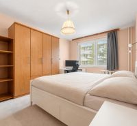 Bedroom in a 4-room apartment with a bed, wardrobe, and desk.