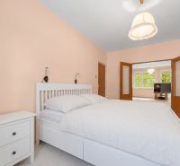 A bright bedroom with white furniture in a 4-room apartment with a view.