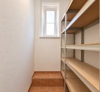 Storage space with shelves and tiles in a 2-room apartment.