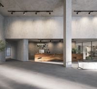 A spacious hall with a reception and minimalist furniture, part of an apartment construction.