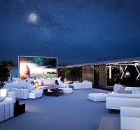 View of the exterior space of apartment construction in Phuket with an outdoor cinema.